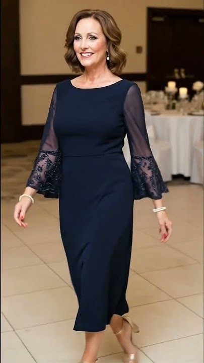 Navy blue midi dress with sheer embellished bell sleeves.