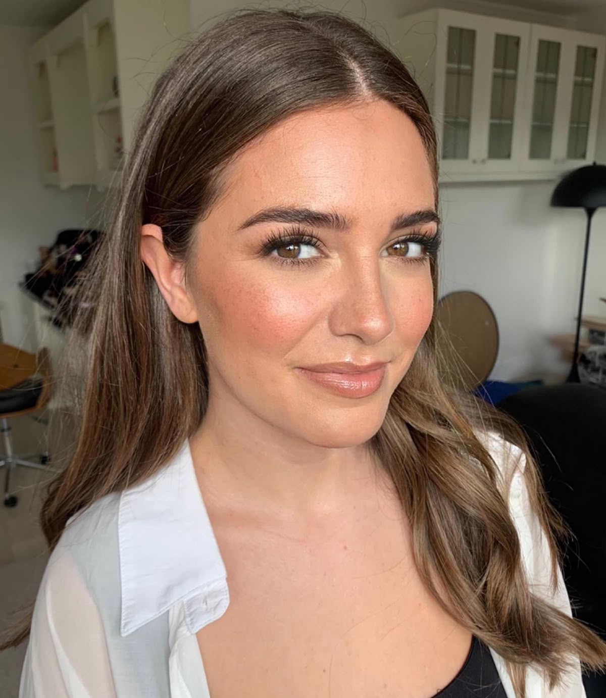 Fresh peachy satin makeup look with soft brows and a healthy skin glow.