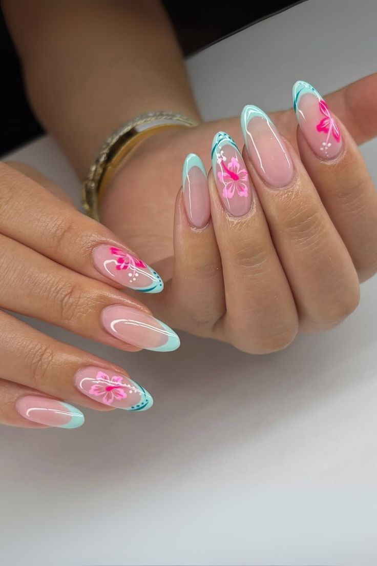 Long almond shaped nails with light mint green French tips and hand painted bright pink hibiscus flowers with white details.