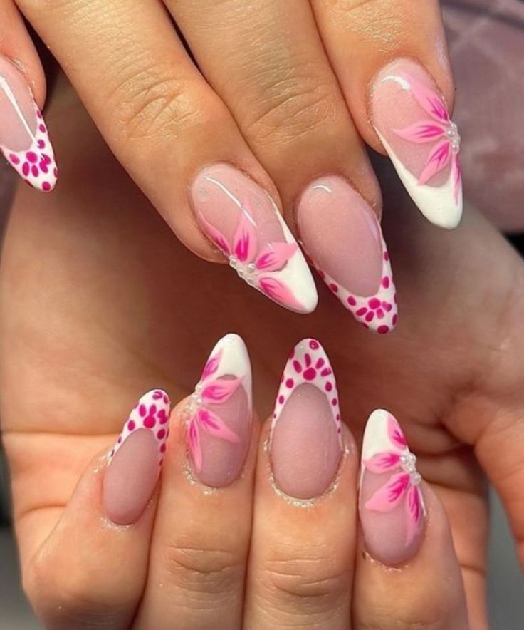 Almond shaped nails featuring hot neon pink sections, crisp white borders, and accent nails decorated with bold black and white zebra stripe patterns.