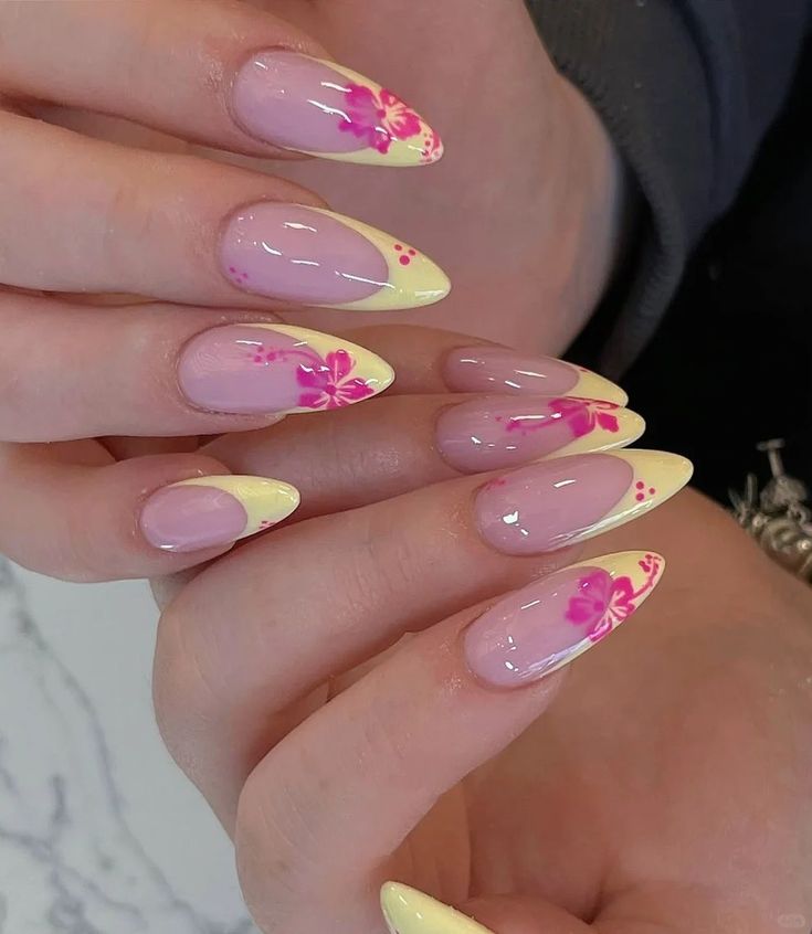 Natural almond shaped nails with clear polish and clean v-shaped French tips painted in a soft pastel lemon yellow shade.