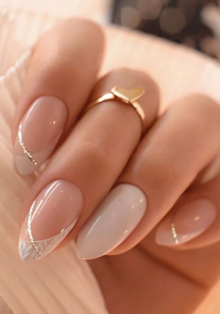 Sheer almond nails with silver glitter curves and white botanical details.