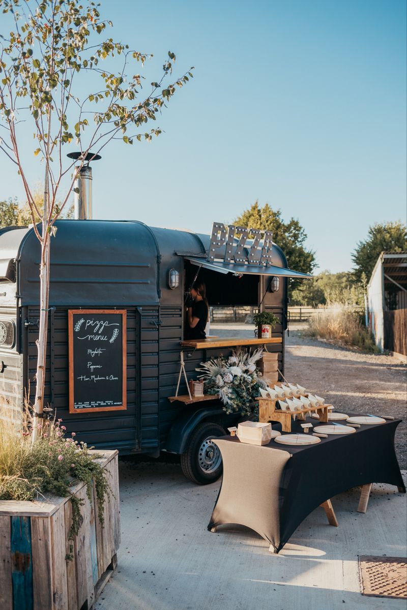 Modern matte black pizza trailer styled for a contemporary wedding.