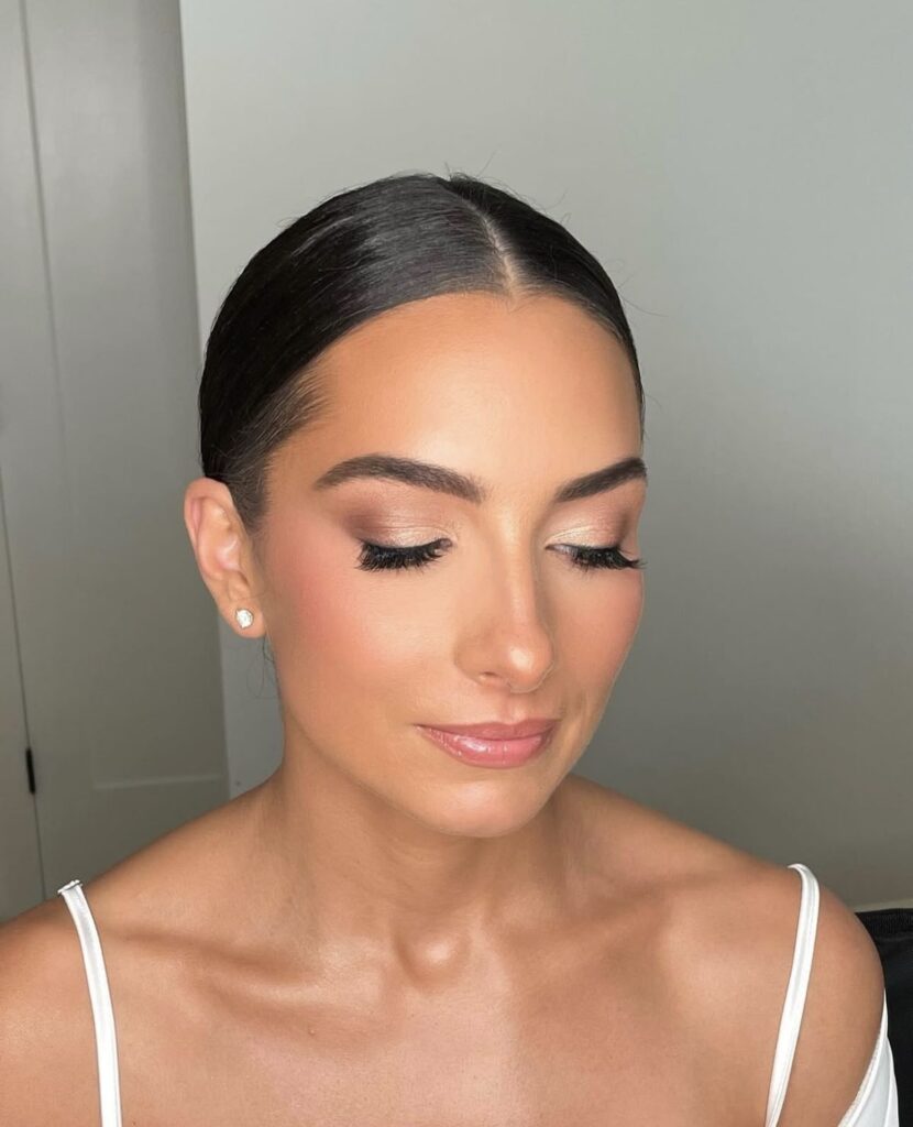 Cut crease technique featuring rose gold shimmer and sculpted eyebrows.
