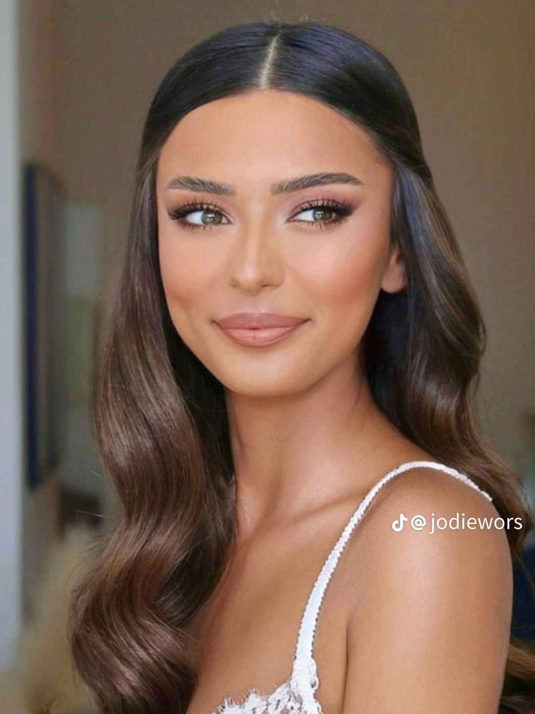 Natural bridal beauty look with shimmering champagne eyeshadow on a bride with deep brown eyes. 
