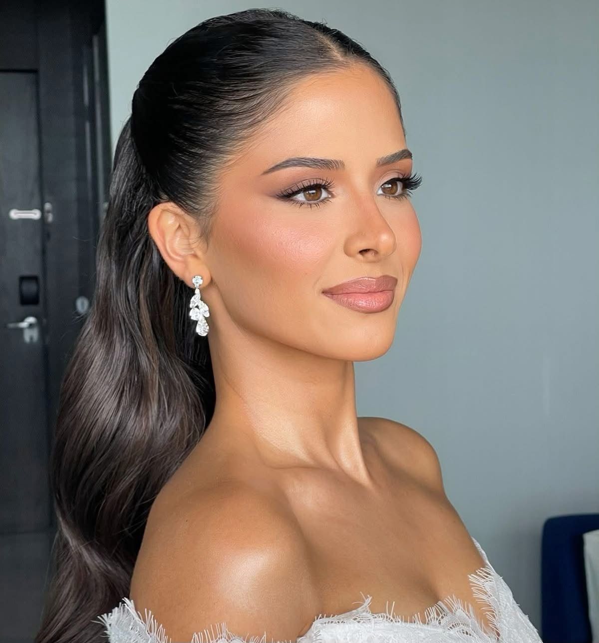 Modern wedding day makeup highlighting brown eyes with warm copper tones and a soft brow. 