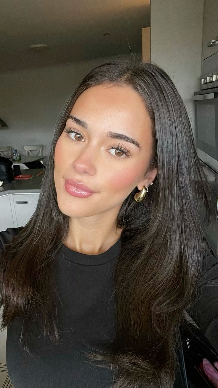 Minimalist wedding makeup look with clean skin and soft gold lid shimmer on brown eyes. 