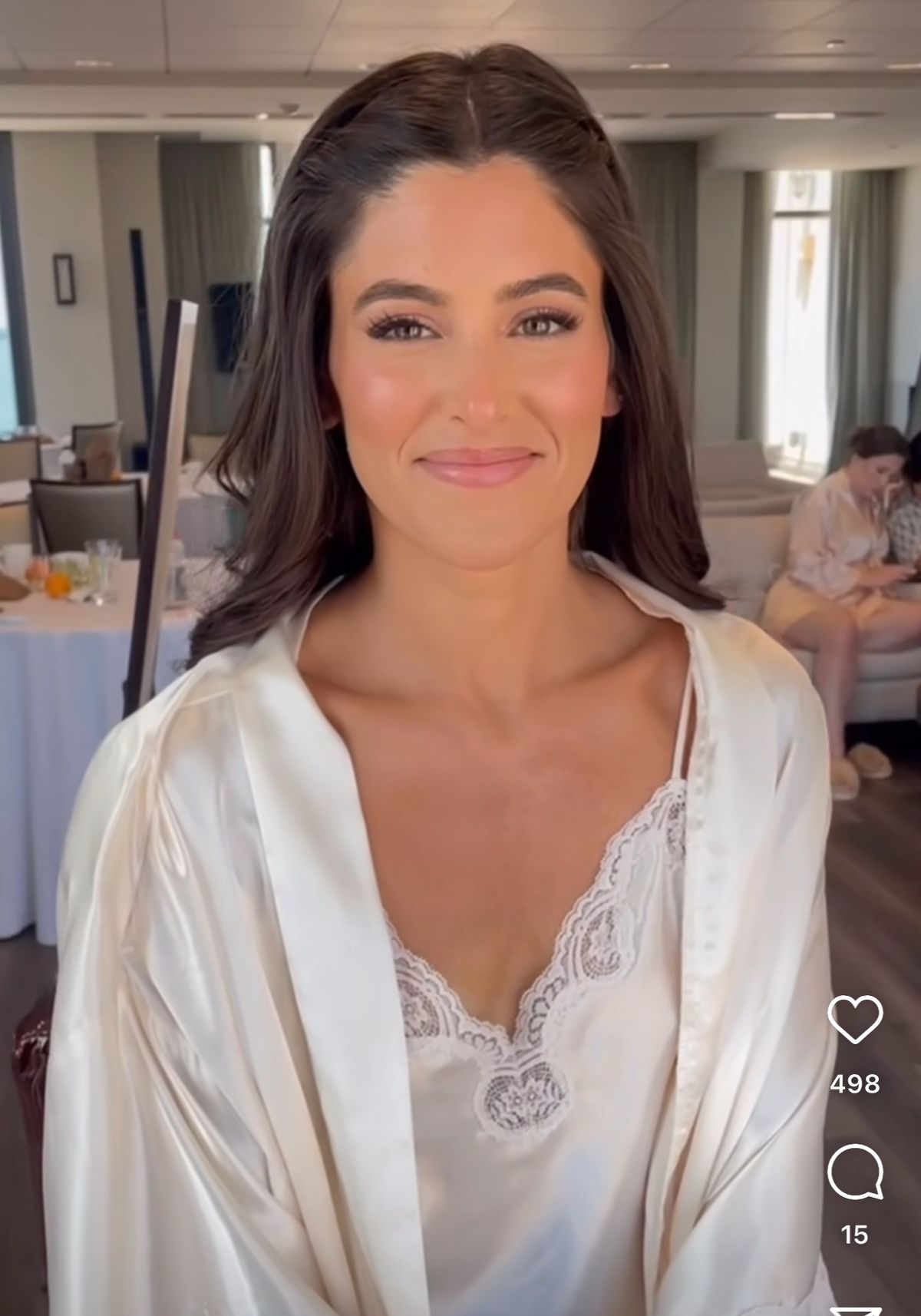 Warm peach-toned wedding makeup highlighting golden clarity in brown eyes.
