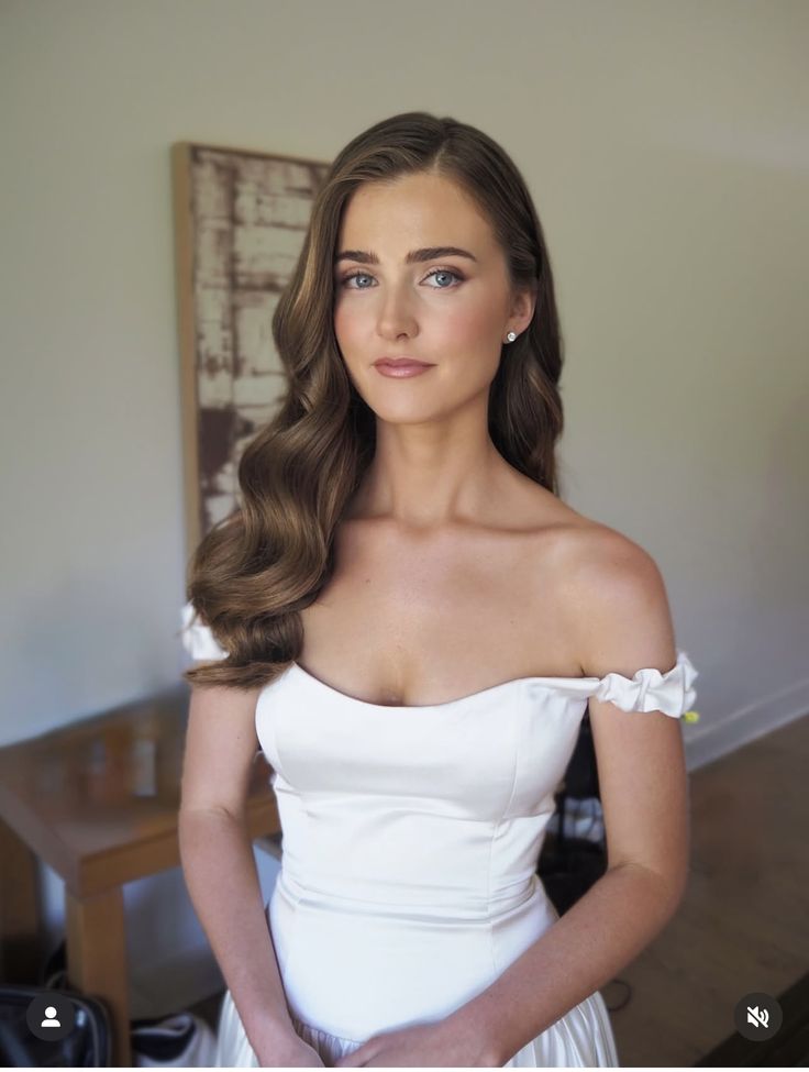 Minimally styled wedding makeup with a clean brow and warm bronzed definition.