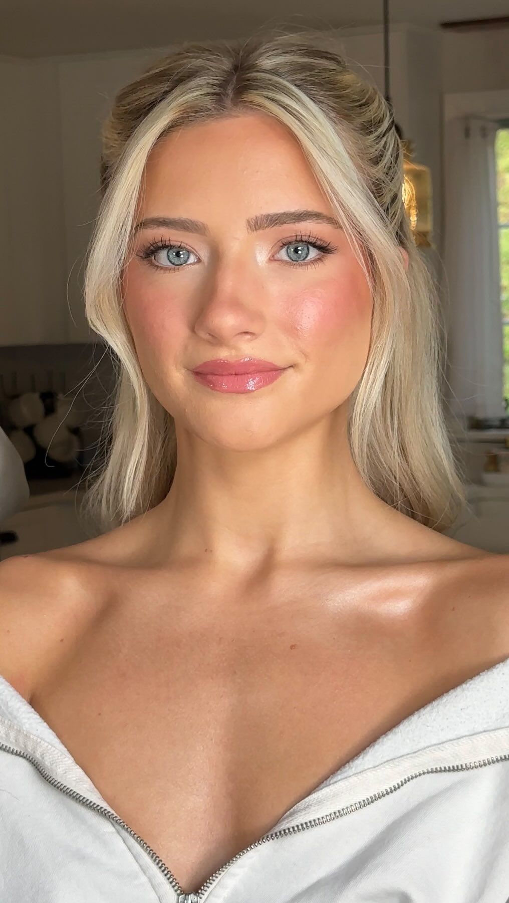 Youthful pink flush across the cheeks paired with a matching glossy pink lip.