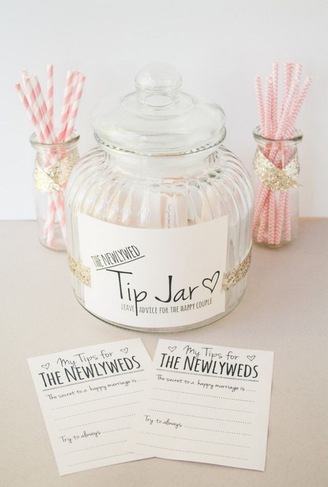 Newlywed advice station with cards and glass jar for marriage messages from guests.