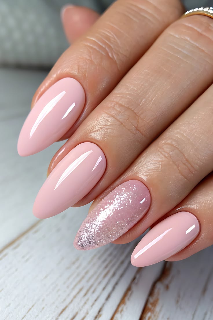 High-shine pink manicure with a matching pink glitter accent nail.