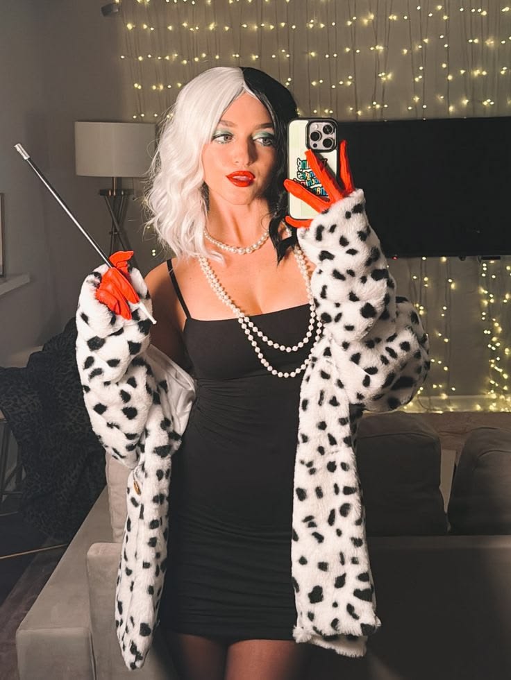 Woman with Cruella-inspired black and white hair, winged eyeliner and bold red lipstick