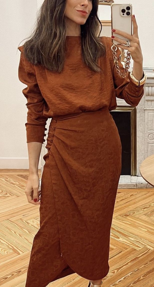 Woman wearing a chocolate brown long sleeve ruched midi dress
